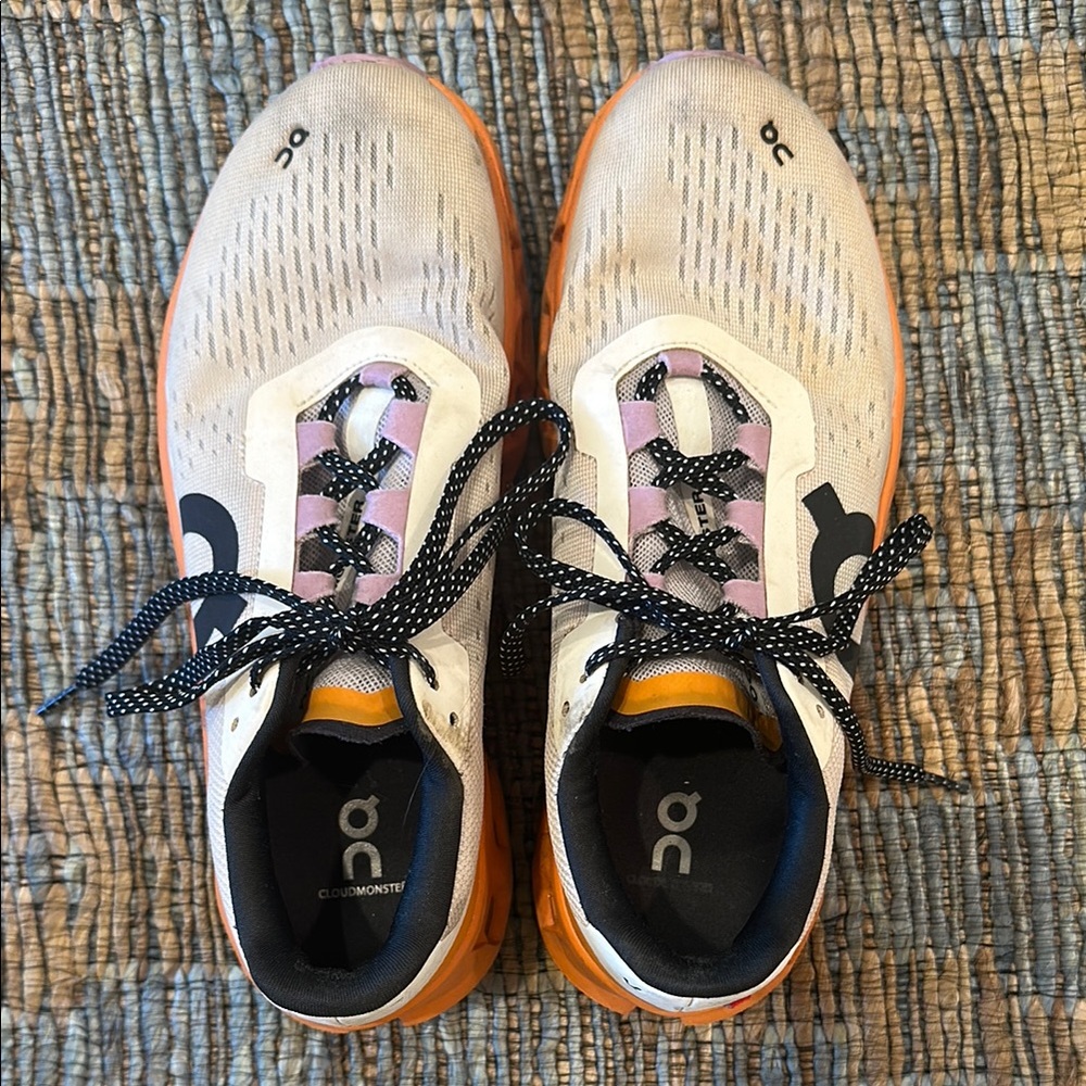 On Running White and Orange Athletic Shoes